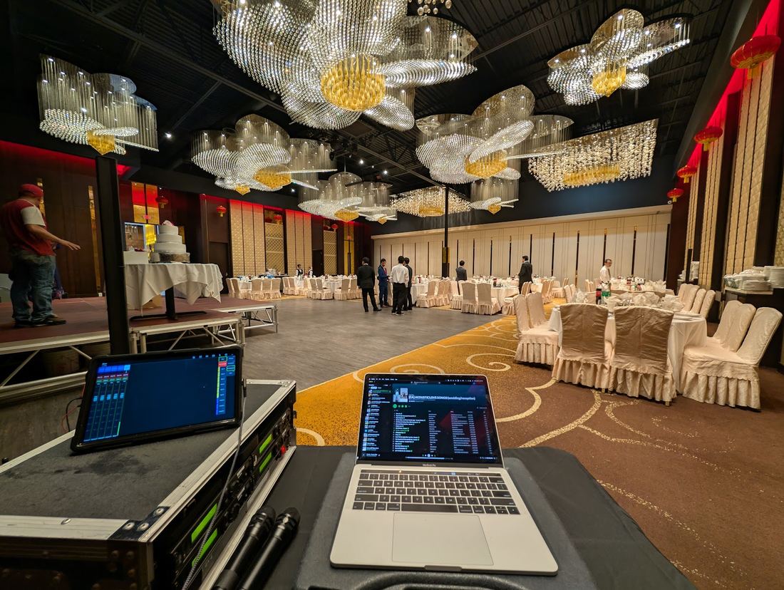 DJ booth facing a ballroom reception