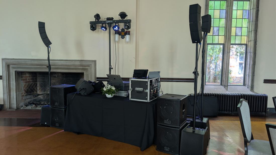 Speakers and lighting in a historic room with a fireplace