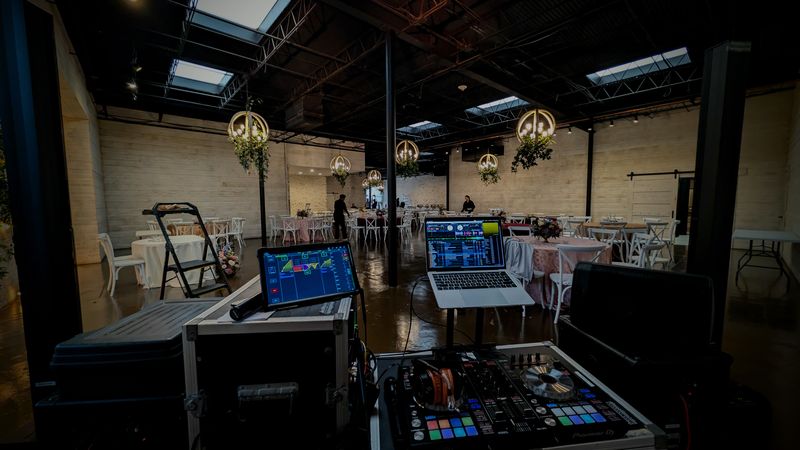 DJ booth setup with dual screens and controller