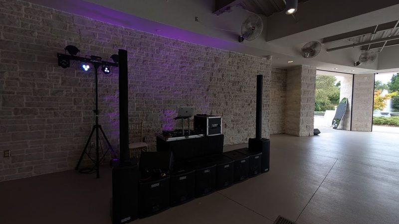 Gig Bar lights and speakers set up against a brick wall with purple uplighting
