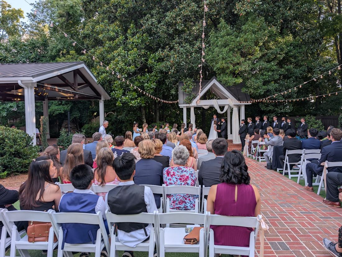 Guests seated for a garden ceremony