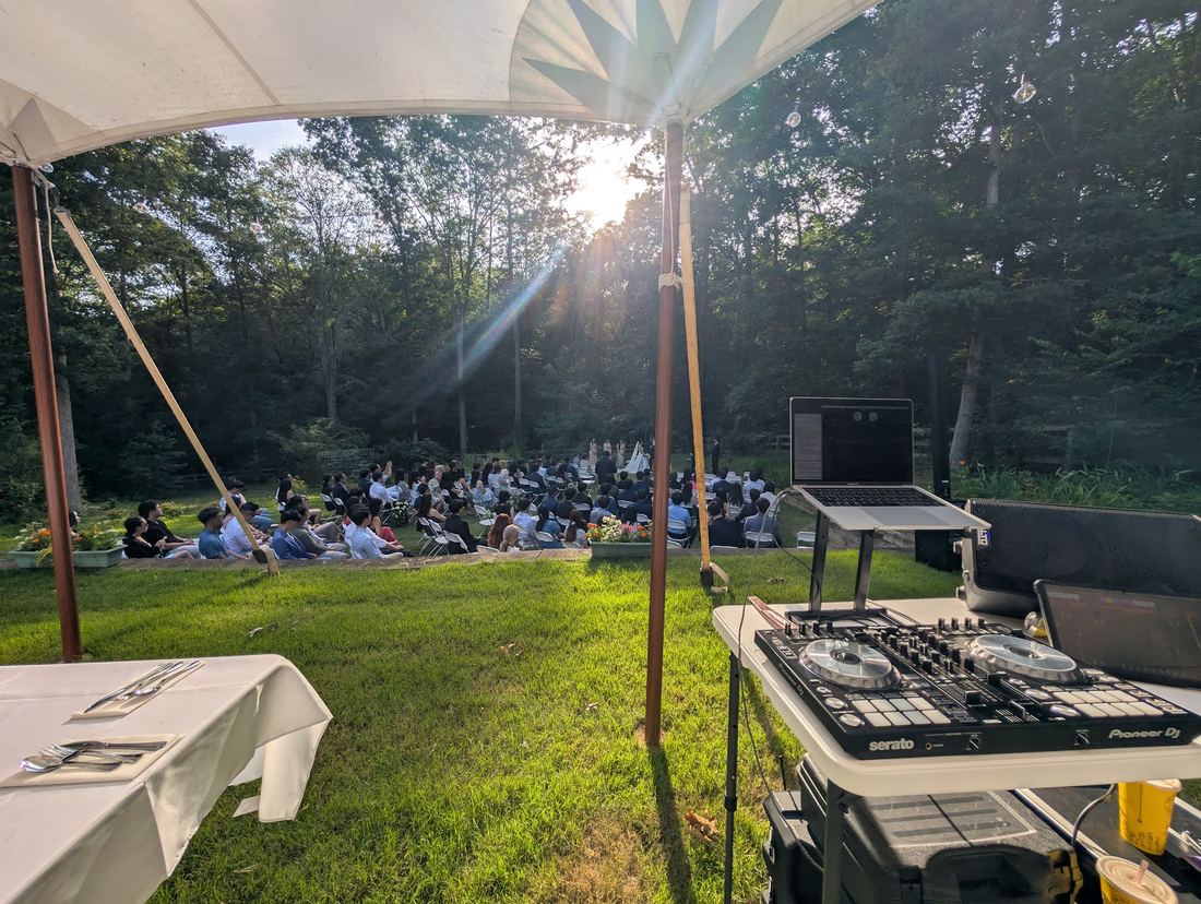 Tented outdoor ceremony at golden hour